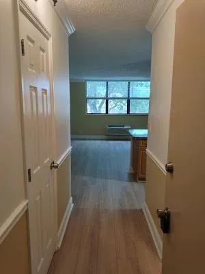 wooden floor in an empty room with a window