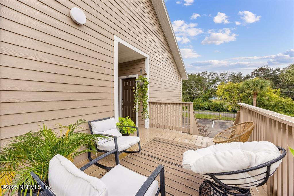 1601 Nectarine Street, Unit I5 Fernandina Beach, FL 32034 - Photo 11 of 22 a view of a patio with couches chairs under an umbrella
