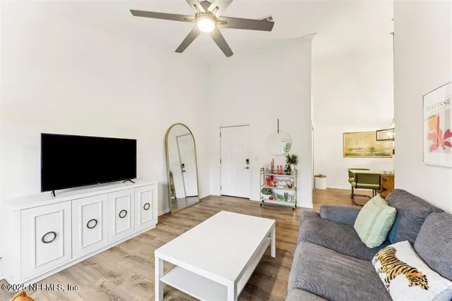 a living room with furniture and a dining table with kitchen view