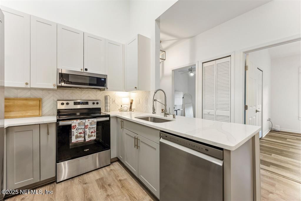 1601 Nectarine Street, Unit I5 Fernandina Beach, FL 32034 - Photo 4 of 22 a kitchen with stainless steel appliances granite countertop a sink stove and refrigerator