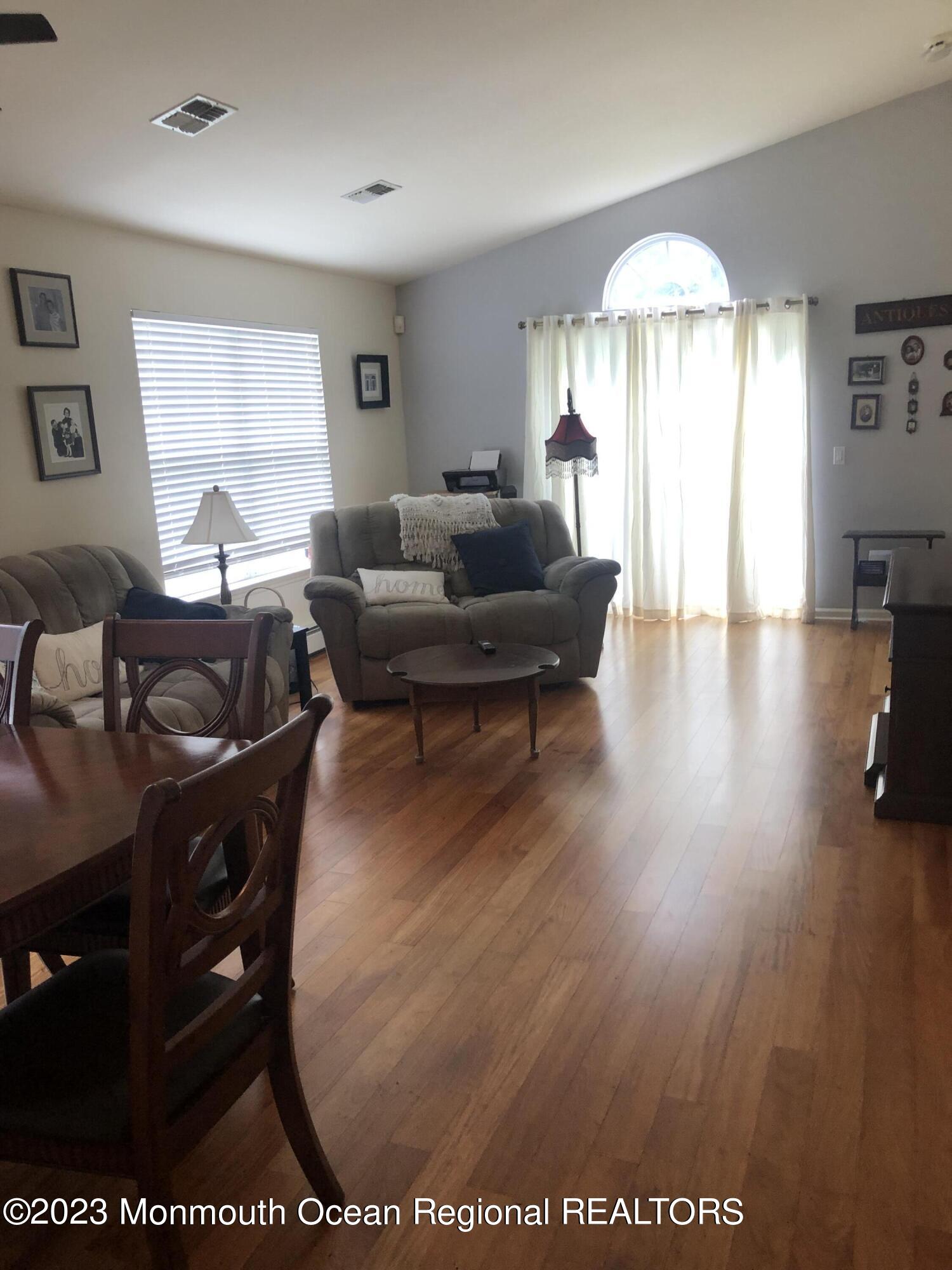 32 Meadows Lane Whiting, NJ 08759 - Photo 3 of 12 a living room with furniture and a chandelier
