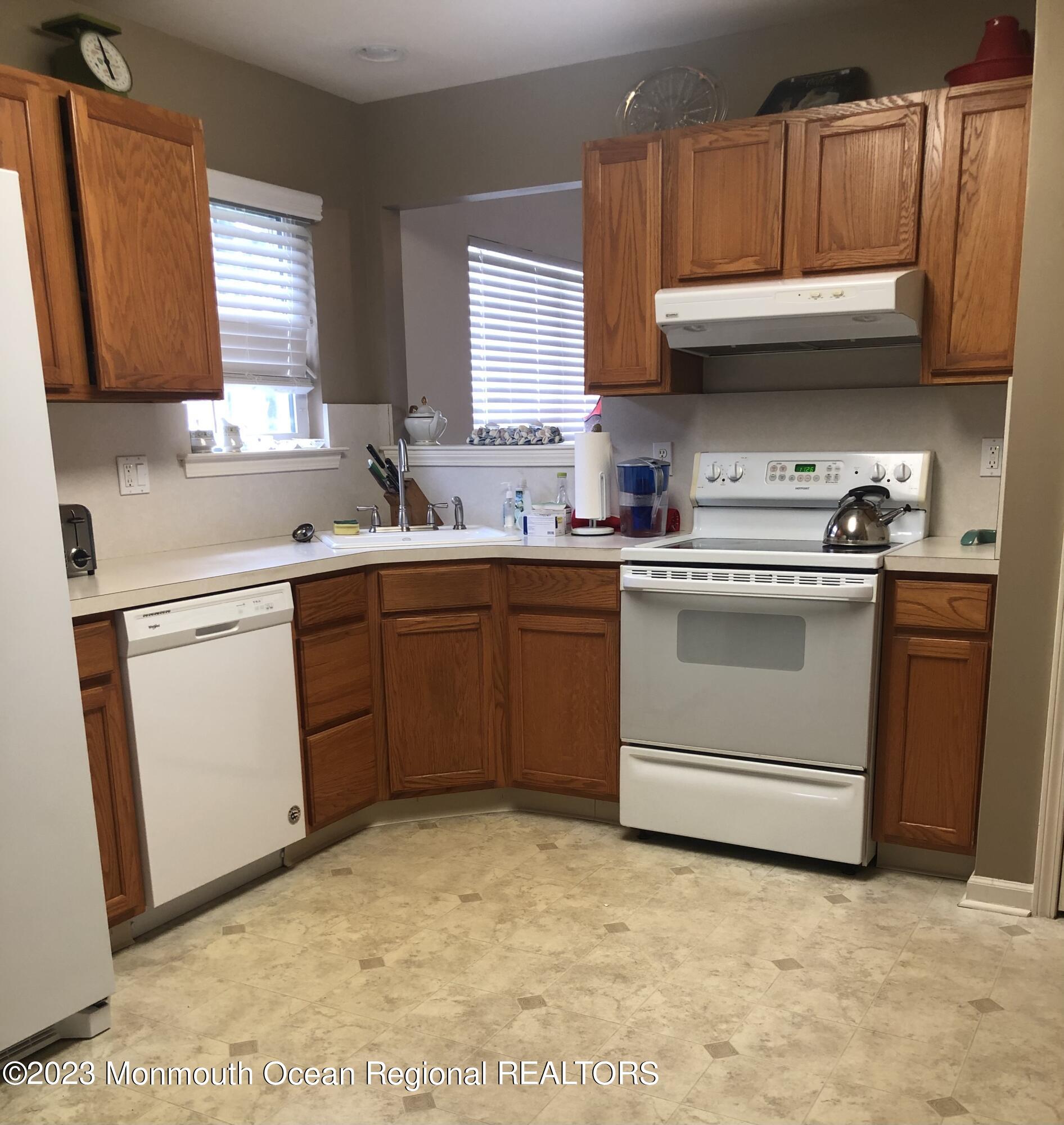 32 Meadows Lane Whiting, NJ 08759 - Photo 7 of 12 a kitchen with a sink stove and cabinets