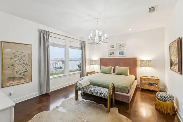 a bedroom with a bed lamps and window