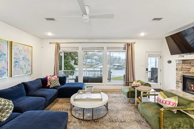 a living room with furniture fireplace and a large window