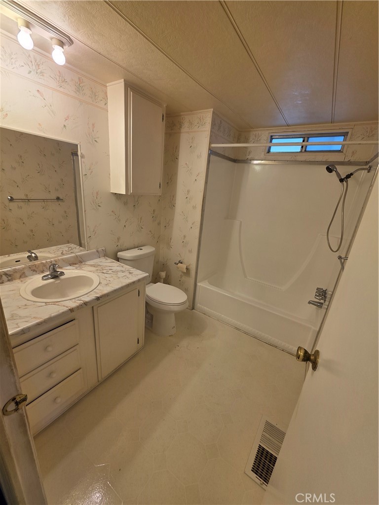 12700 2nd Street, Unit 35 Yucaipa, CA 92399 - Photo 13 of 15 a bathroom with a sink a toilet and shower