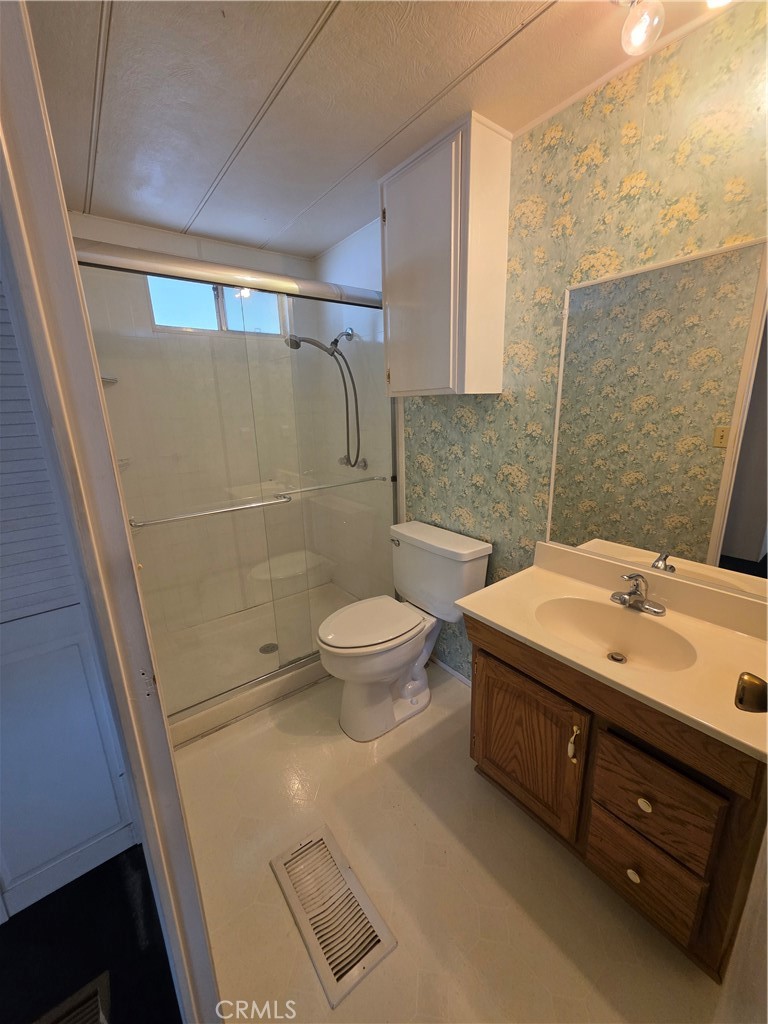 12700 2nd Street, Unit 35 Yucaipa, CA 92399 - Photo 14 of 15 a bathroom with a sink a toilet and shower