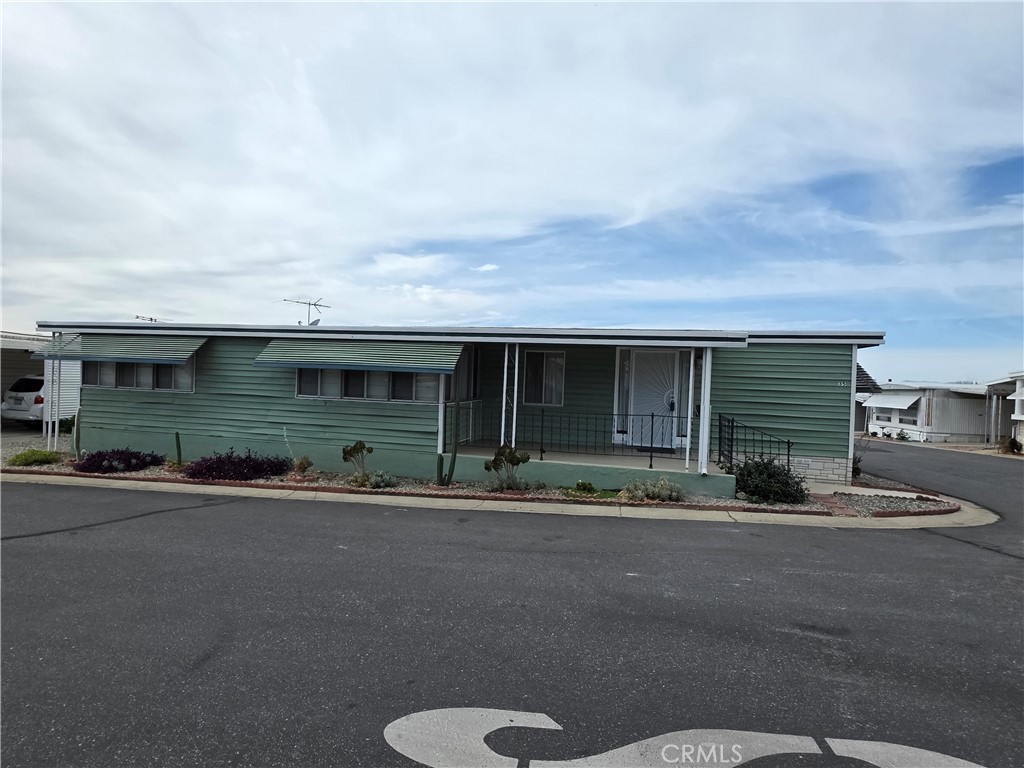 12700 2nd Street, Unit 35 Yucaipa, CA 92399 - Photo 2 of 15 a front view of a house with a yard and garage