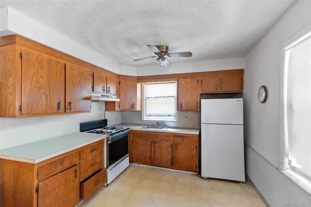 a kitchen with stainless steel appliances a refrigerator sink and cabinets