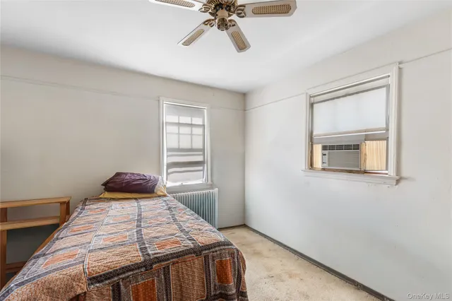 a bedroom with a bed and window