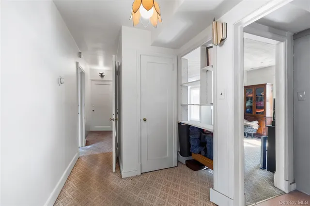 a view of hallway with livingroom and furniture