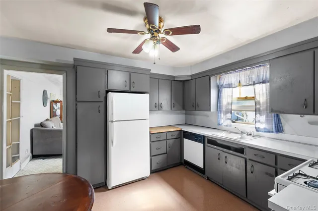 a kitchen with a refrigerator a sink and cabinets