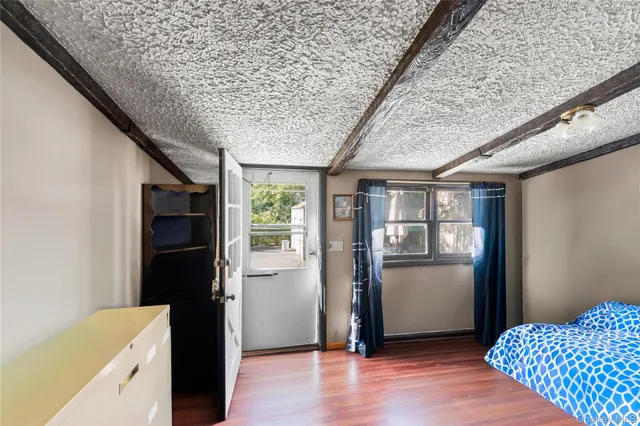 a view of walk in closet with wooden floor