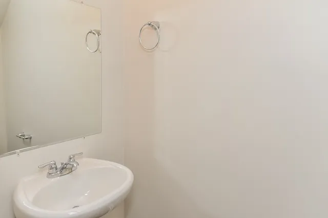 a bathroom with a sink and mirror