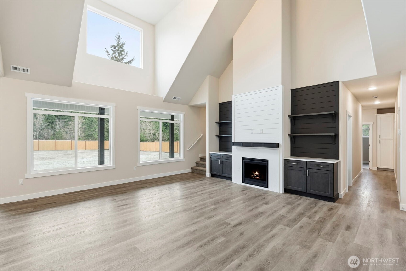 841 Barbara Lane, Unit SW Centralia, WA 98531 - Photo 2 of 28 an empty room with fireplace cabinet and windows