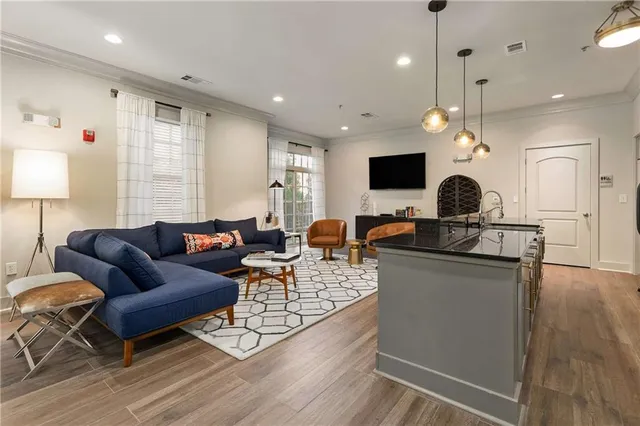 a living room with furniture and kitchen view