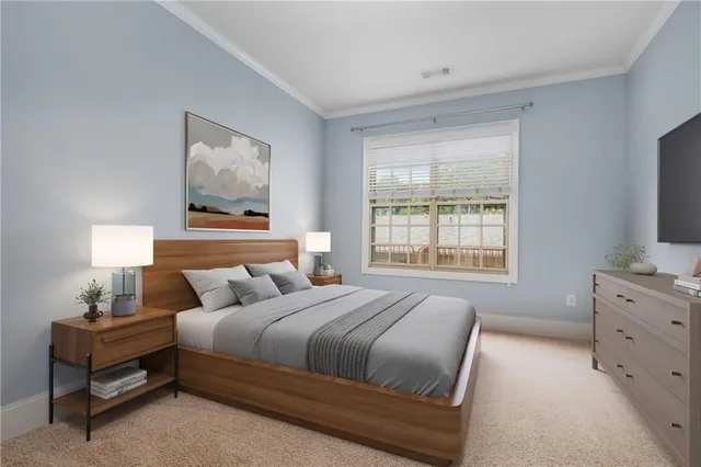 a bedroom with a bed and a flat tv screen on the dresser