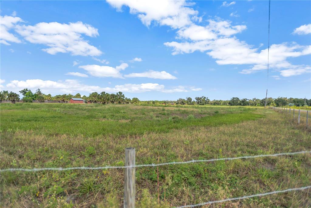 Bunker Hil Road, Unit PARCEL E Parrish, FL 34219 - Photo 12 of 12 a view of a garden with a building in the background