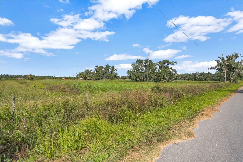 Bunker Hil Road, Unit PARCEL E Parrish, FL 34219 - Photo 7 of 12 a view of a lake with a big yard