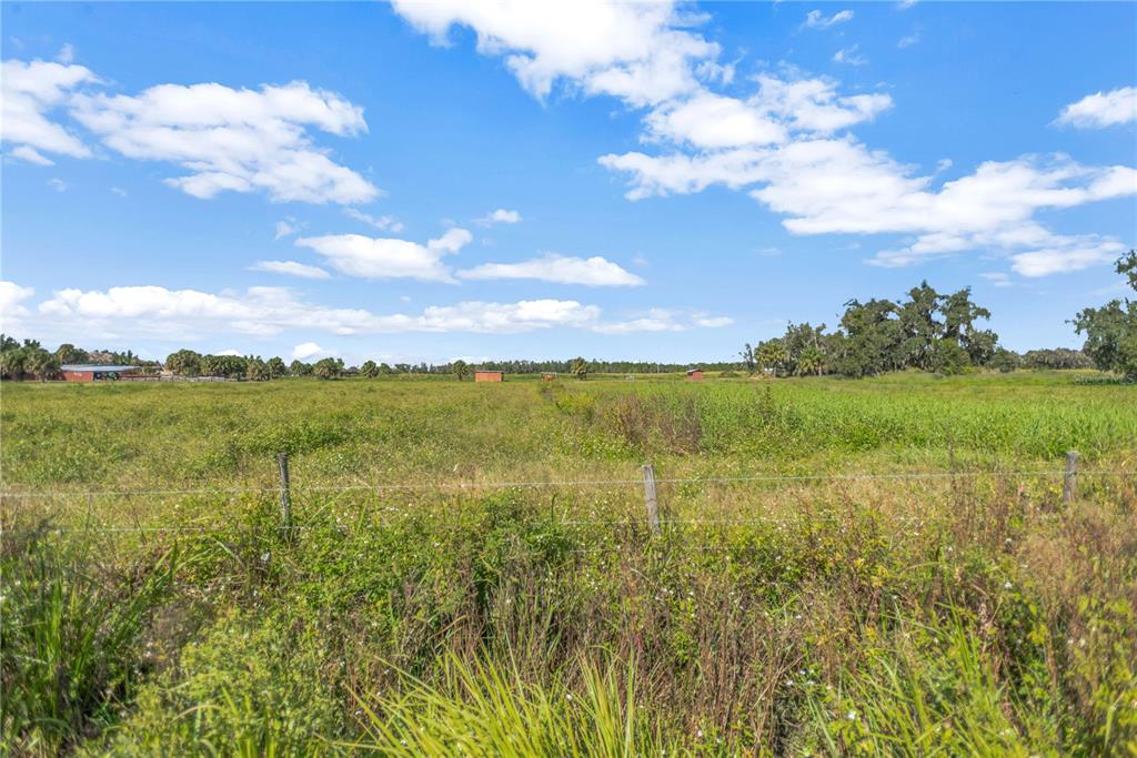 Bunker Hil Road, Unit PARCEL E Parrish, FL 34219 - Photo 8 of 12 a view of a lake with houses in the back