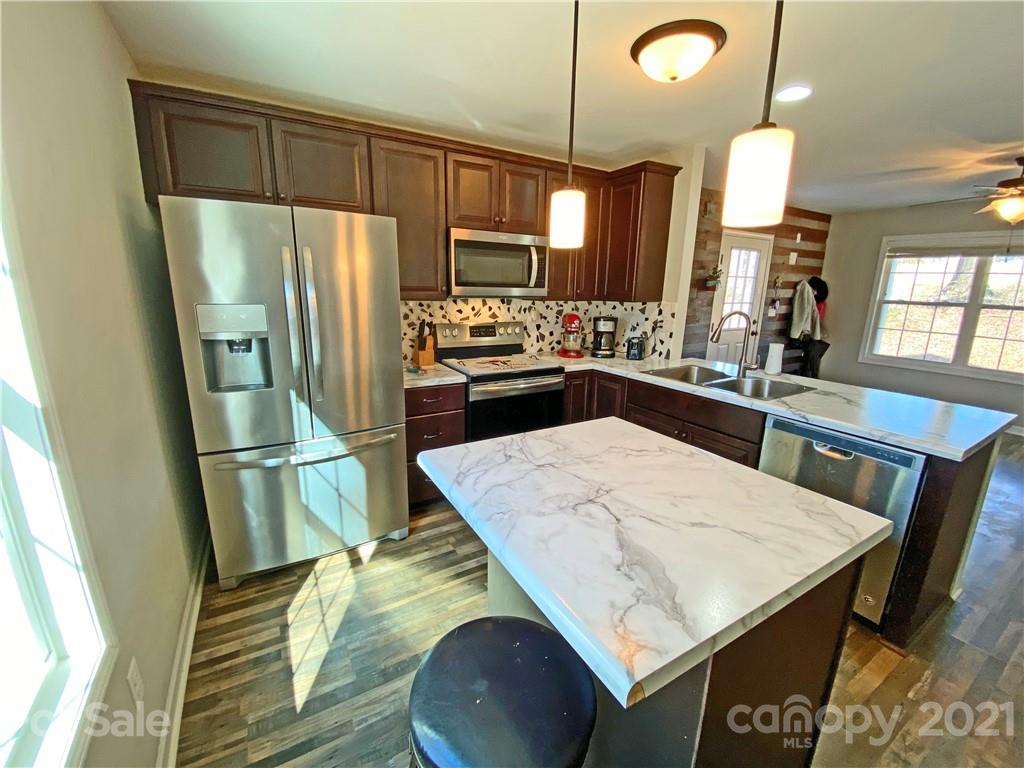1817 St Marks Church Road Crouse, NC 28033 - Photo 2 of 35 a kitchen with stainless steel appliances a refrigerator a sink a stove and white cabinets