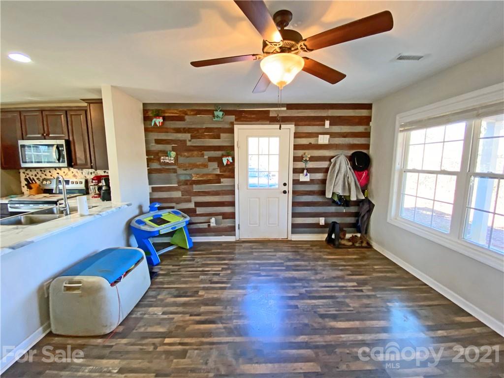 1817 St Marks Church Road Crouse, NC 28033 - Photo 11 of 35 a living room filled with furniture and a chandelier