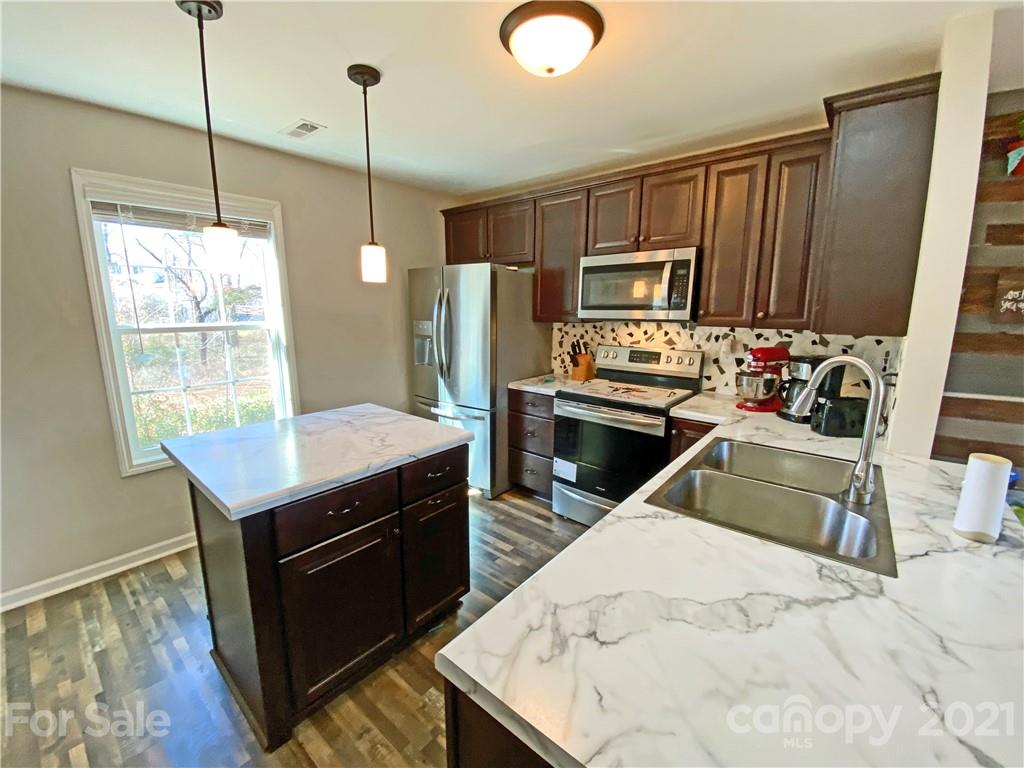1817 St Marks Church Road Crouse, NC 28033 - Photo 3 of 35 a kitchen with stainless steel appliances kitchen island granite countertop a stove a sink and a refrigerator