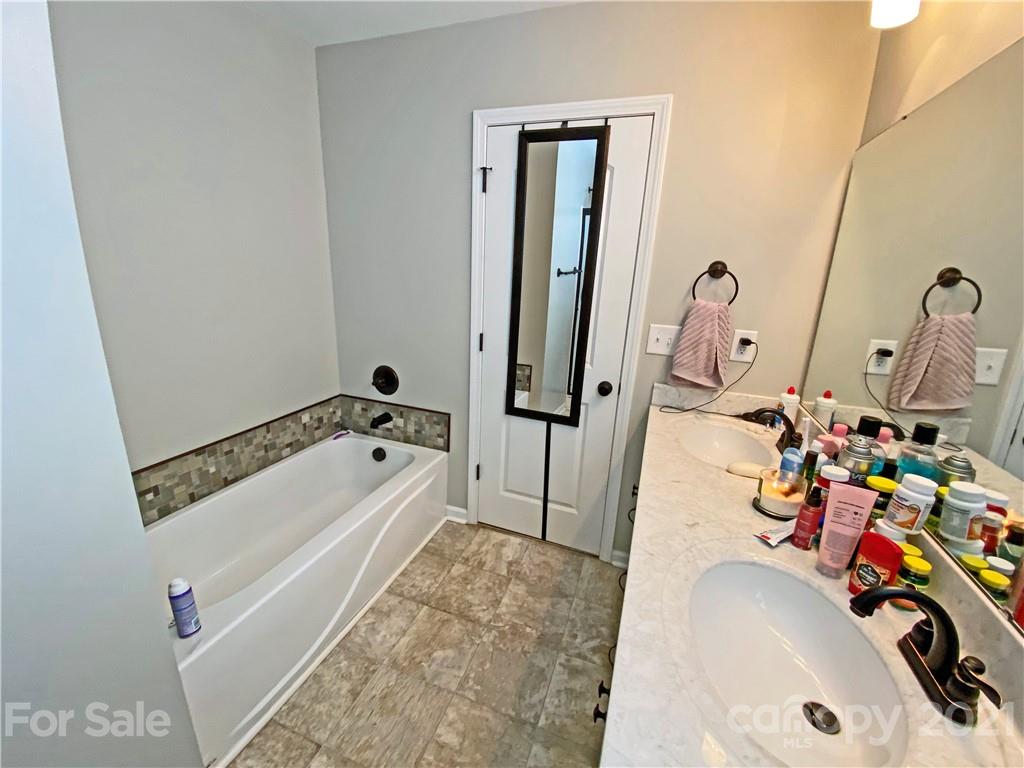 1817 St Marks Church Road Crouse, NC 28033 - Photo 23 of 35 a bathroom with a tub sink and a mirror