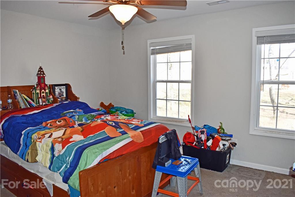 1817 St Marks Church Road Crouse, NC 28033 - Photo 24 of 35 a bedroom with a bed and a chandelier
