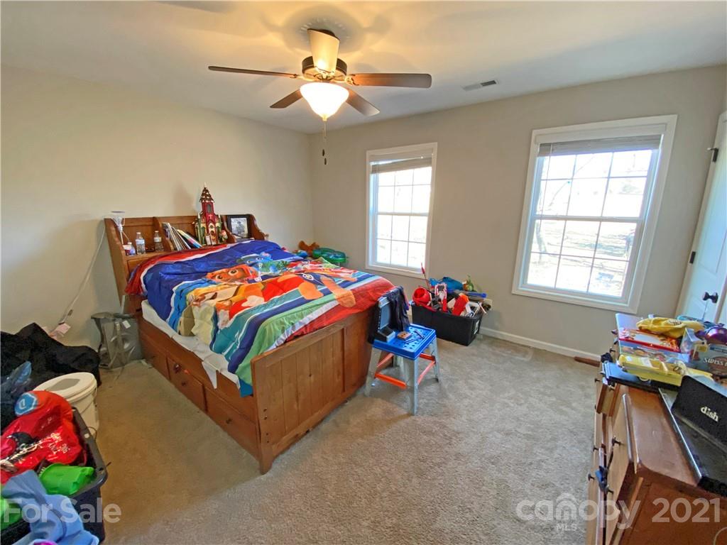 1817 St Marks Church Road Crouse, NC 28033 - Photo 26 of 35 a bedroom with a bed and a chandelier