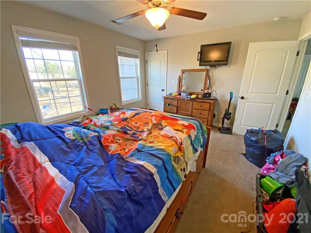 1817 St Marks Church Road Crouse, NC 28033 - Photo 27 of 35 a bedroom with a bed and a chandelier