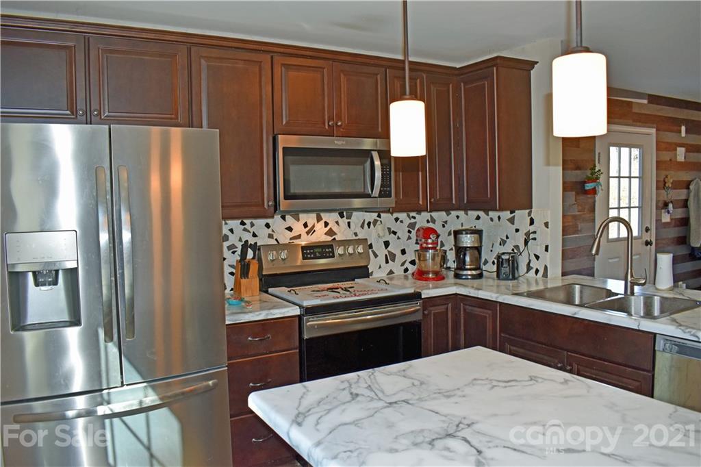 1817 St Marks Church Road Crouse, NC 28033 - Photo 4 of 35 a kitchen with kitchen island granite countertop a sink stainless steel appliances and cabinets