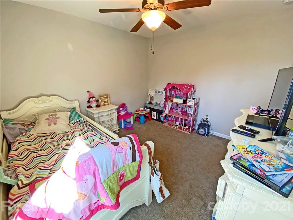 1817 St Marks Church Road Crouse, NC 28033 - Photo 34 of 35 a bedroom with a bed a dresser and a chandelier