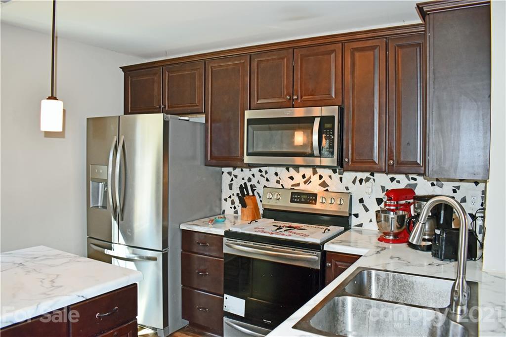 1817 St Marks Church Road Crouse, NC 28033 - Photo 5 of 35 a kitchen with stainless steel appliances a stove microwave and refrigerator