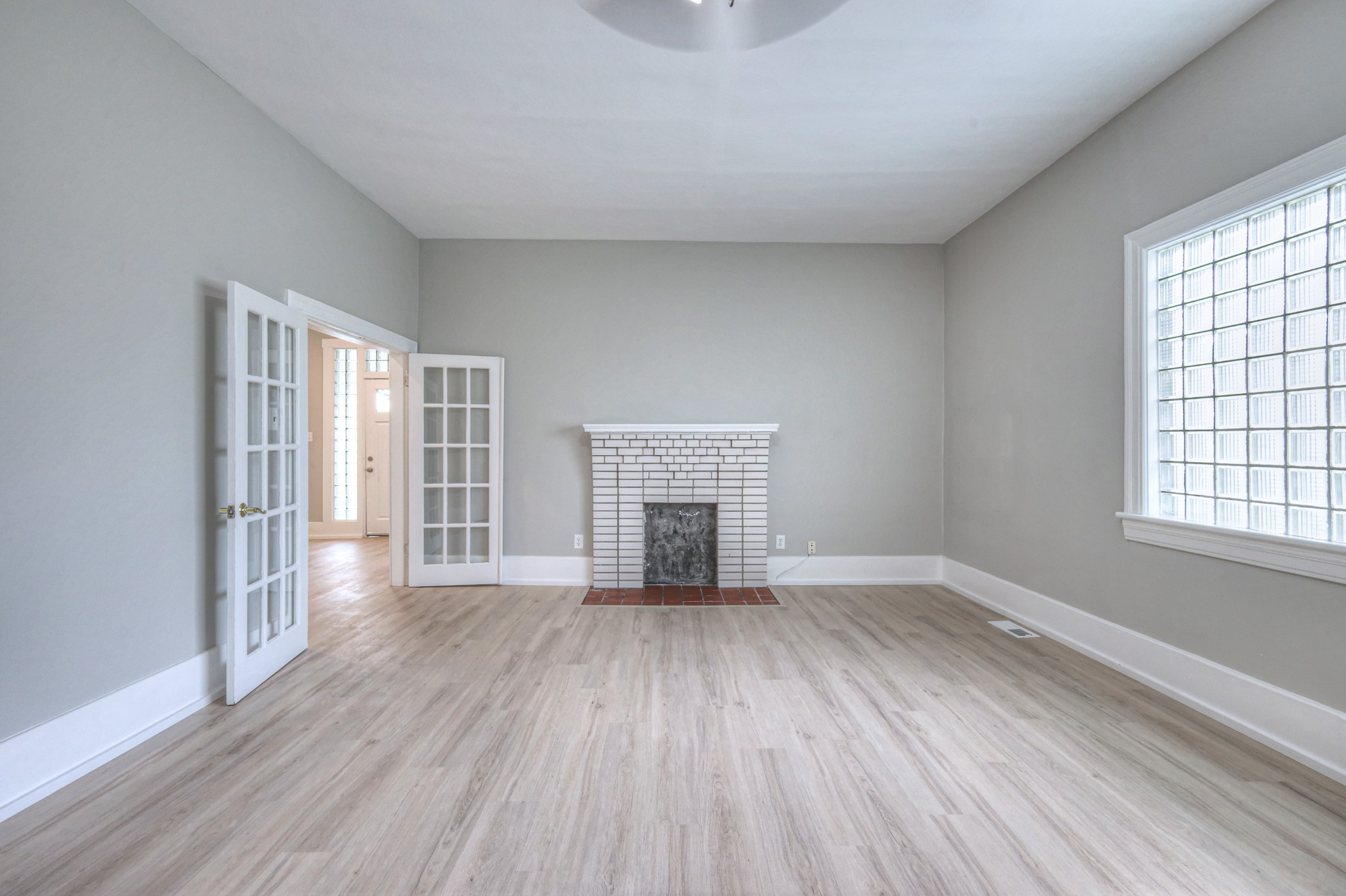108 Church Street Mount Pleasant, TN 38474 - Photo 17 of 45 wooden floor fireplace and windows in an empty room