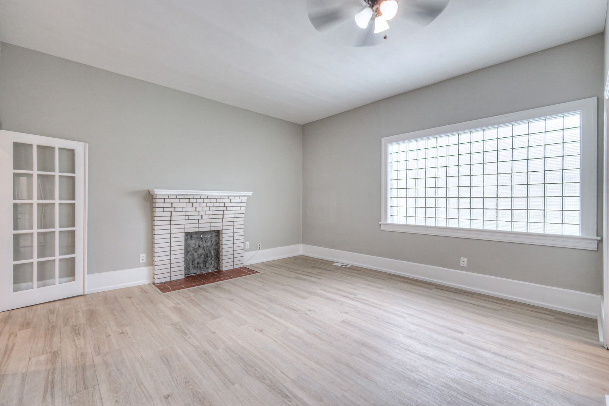 108 Church Street Mount Pleasant, TN 38474 - Photo 23 of 45 an empty room with windows fireplace and windows