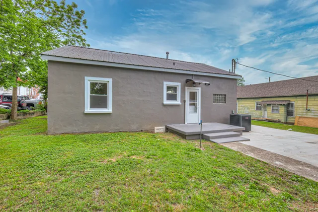 a view of a house with a yard and sitting area