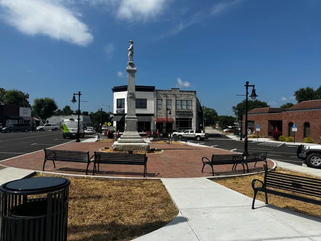 a living room with furniture a red lamp and a table