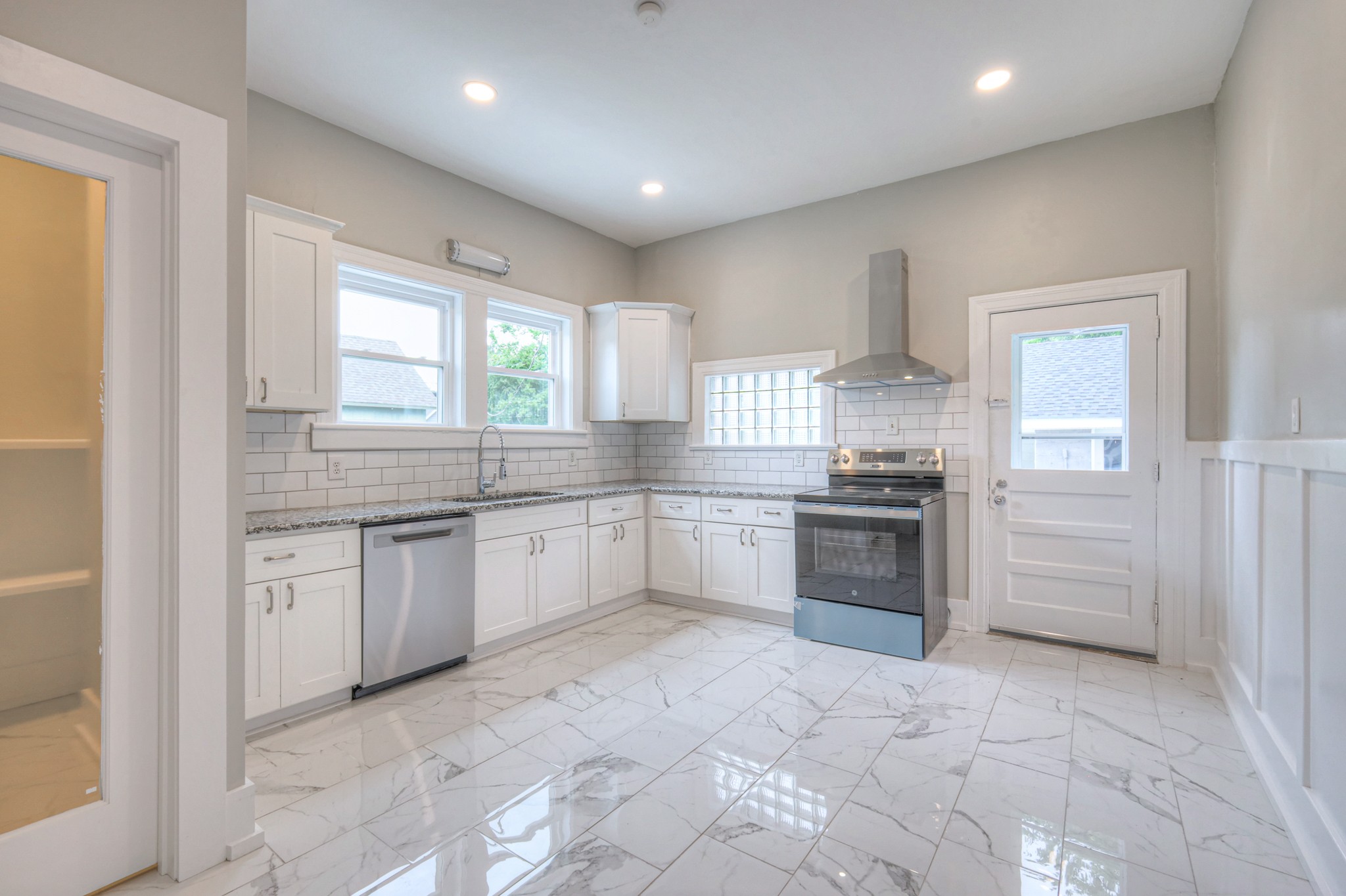 108 Church Street Mount Pleasant, TN 38474 - Photo 6 of 45 a large white kitchen with a sink and cabinets