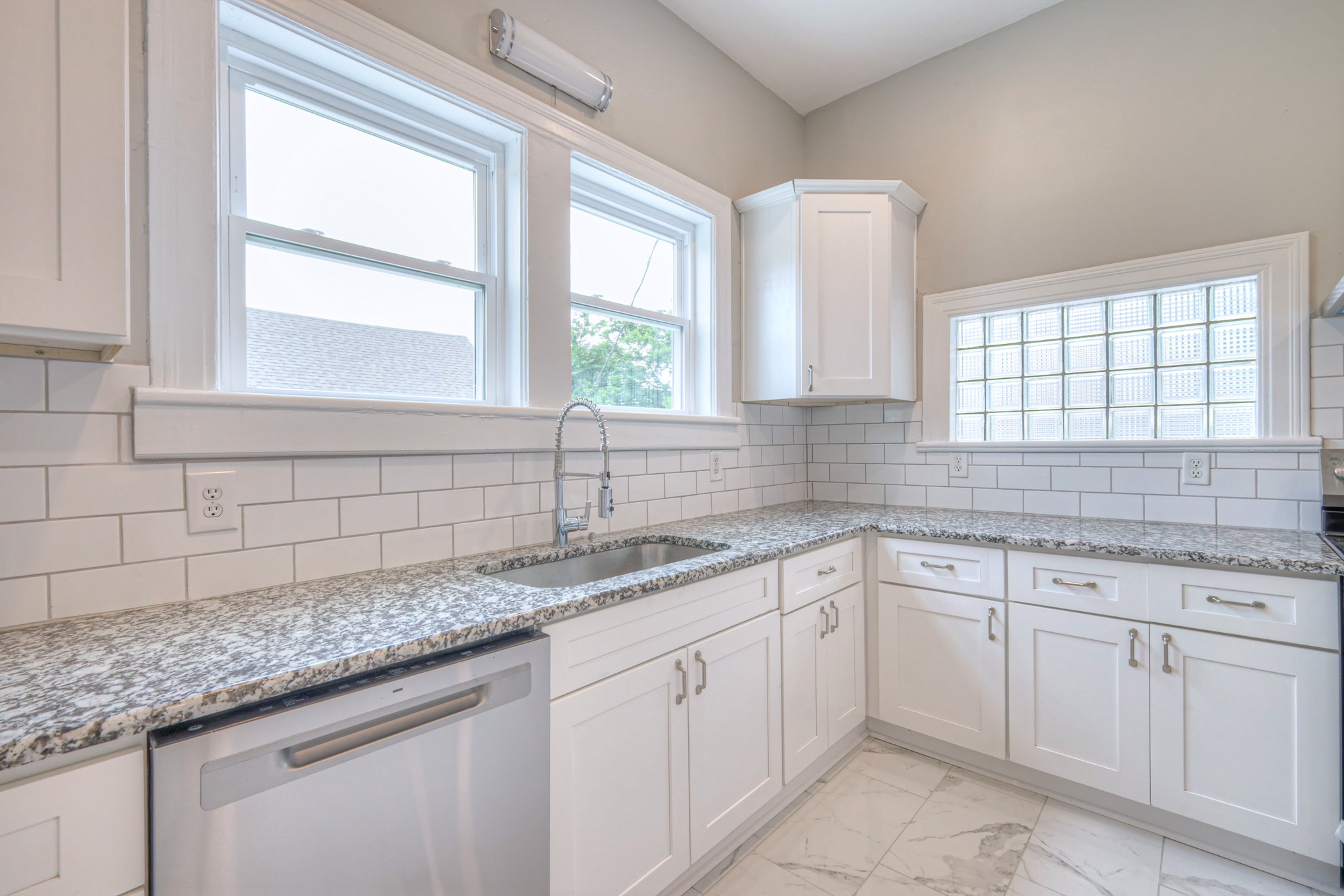108 Church Street Mount Pleasant, TN 38474 - Photo 9 of 45 a kitchen with white cabinets and a window