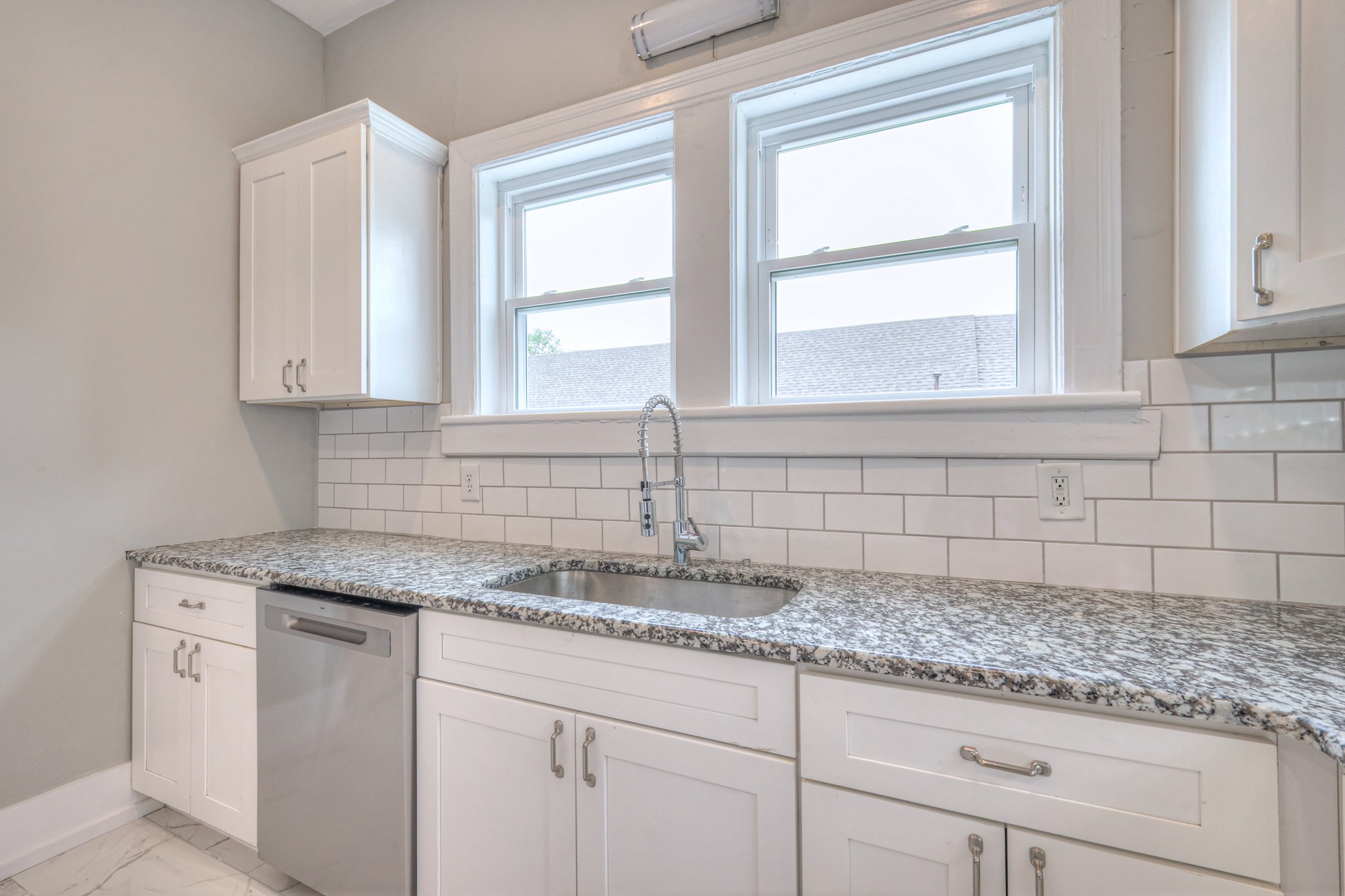 108 Church Street Mount Pleasant, TN 38474 - Photo 10 of 45 a kitchen with granite countertop a sink cabinets and window