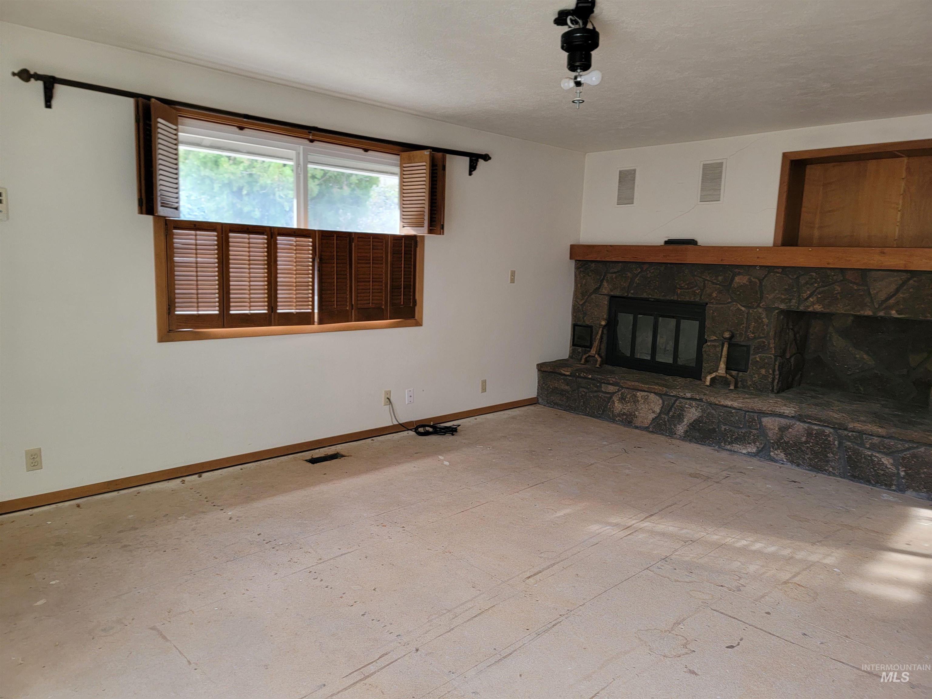 3311 Snowflake Way Boise, ID 83706 - Photo 8 of 14 Unfurnished living room featuring a fireplace and baseboards