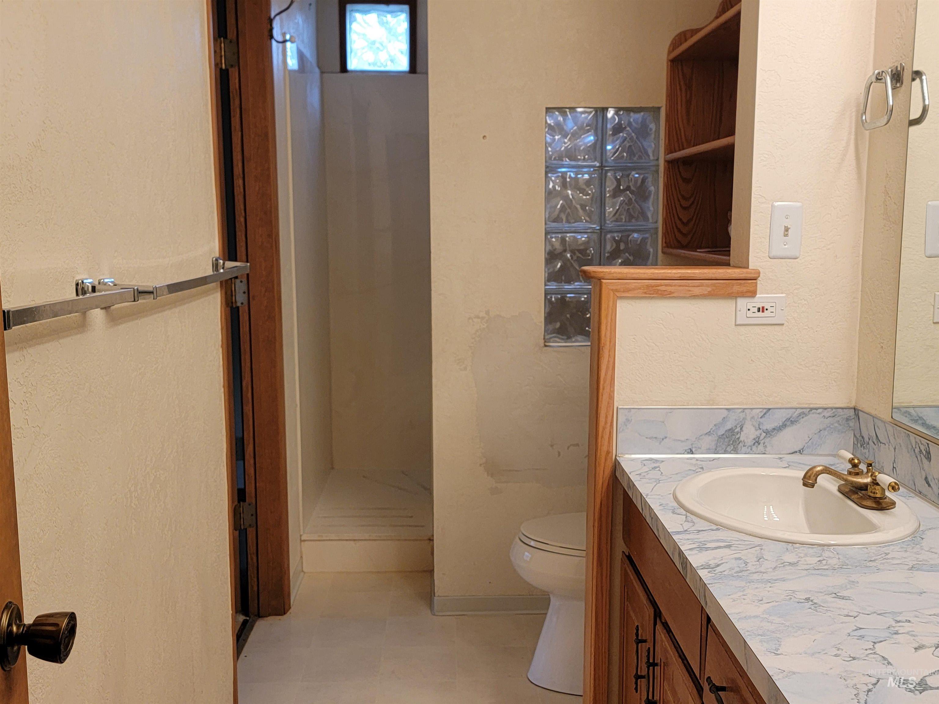 3311 Snowflake Way Boise, ID 83706 - Photo 10 of 14 Bathroom with vanity, a shower stall, a textured wall, and light floors