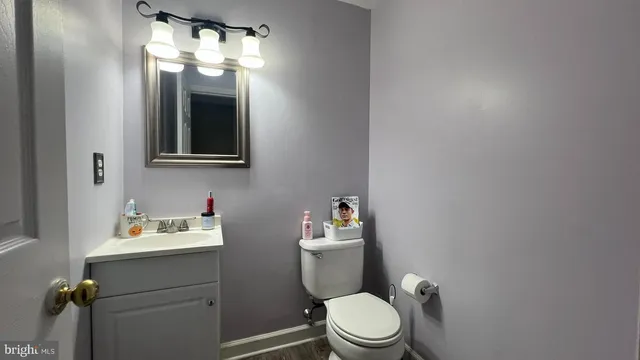 a bathroom with a toilet sink and mirror