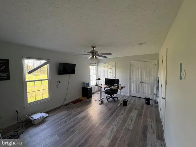 a view of a livingroom with furniture and a window