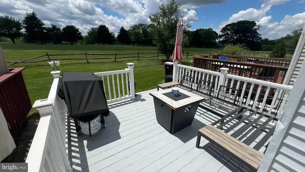 a view of a wooden deck with furniture