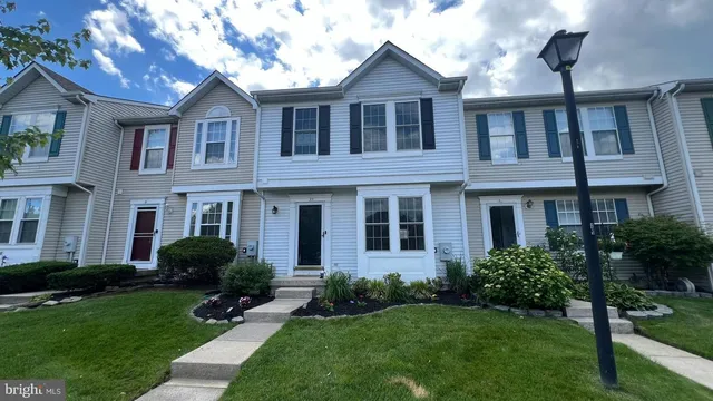 a front view of a house with garden and porch