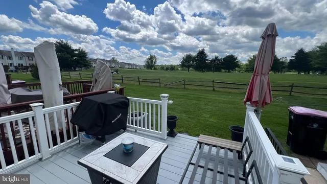 a view of a deck with chair and wooden floor