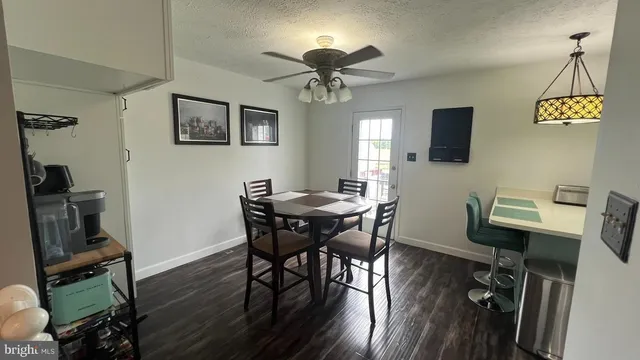 a view of a dining room with furniture a chandelier and wooden floor