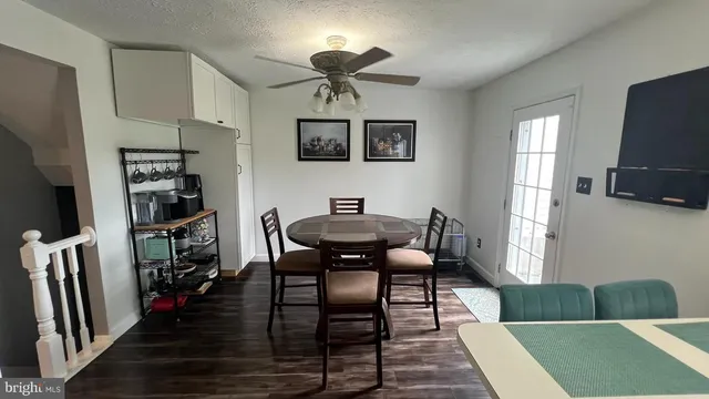 a living room with furniture a rug and a flat screen tv