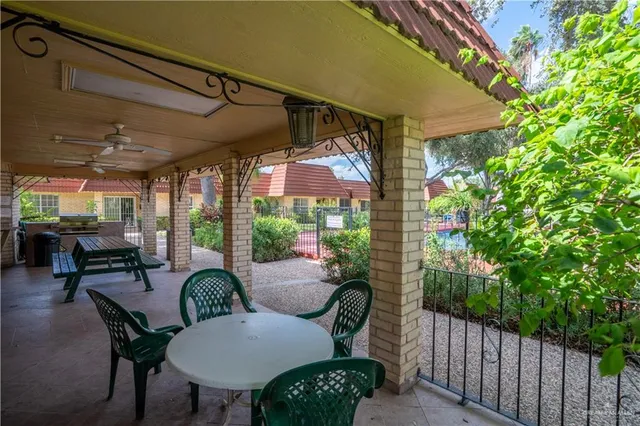 a view of a patio with table and chairs and potted plants